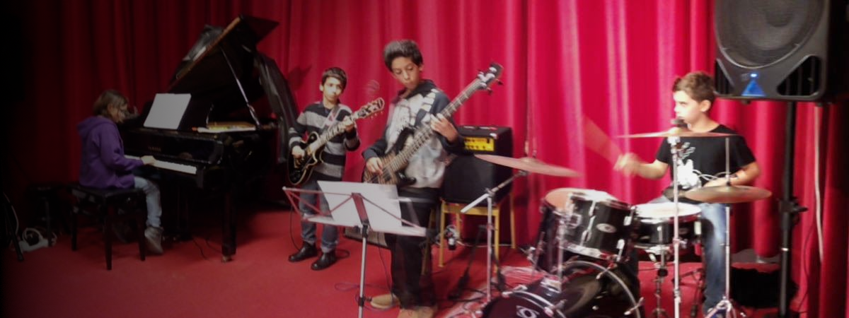 Allievi del Rock Lab Musictime durante una prova di musica d’insieme con pianoforte, chitarra, basso e batteria